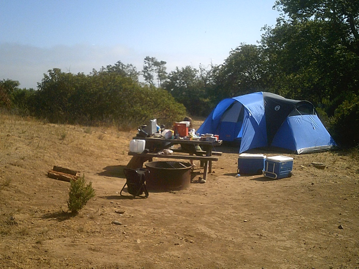 A booked State Parks campsite with tent, table and fire ring