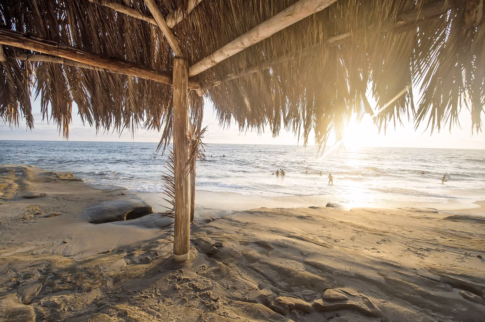 A thatched beach shelter on a sunny Southern California beach